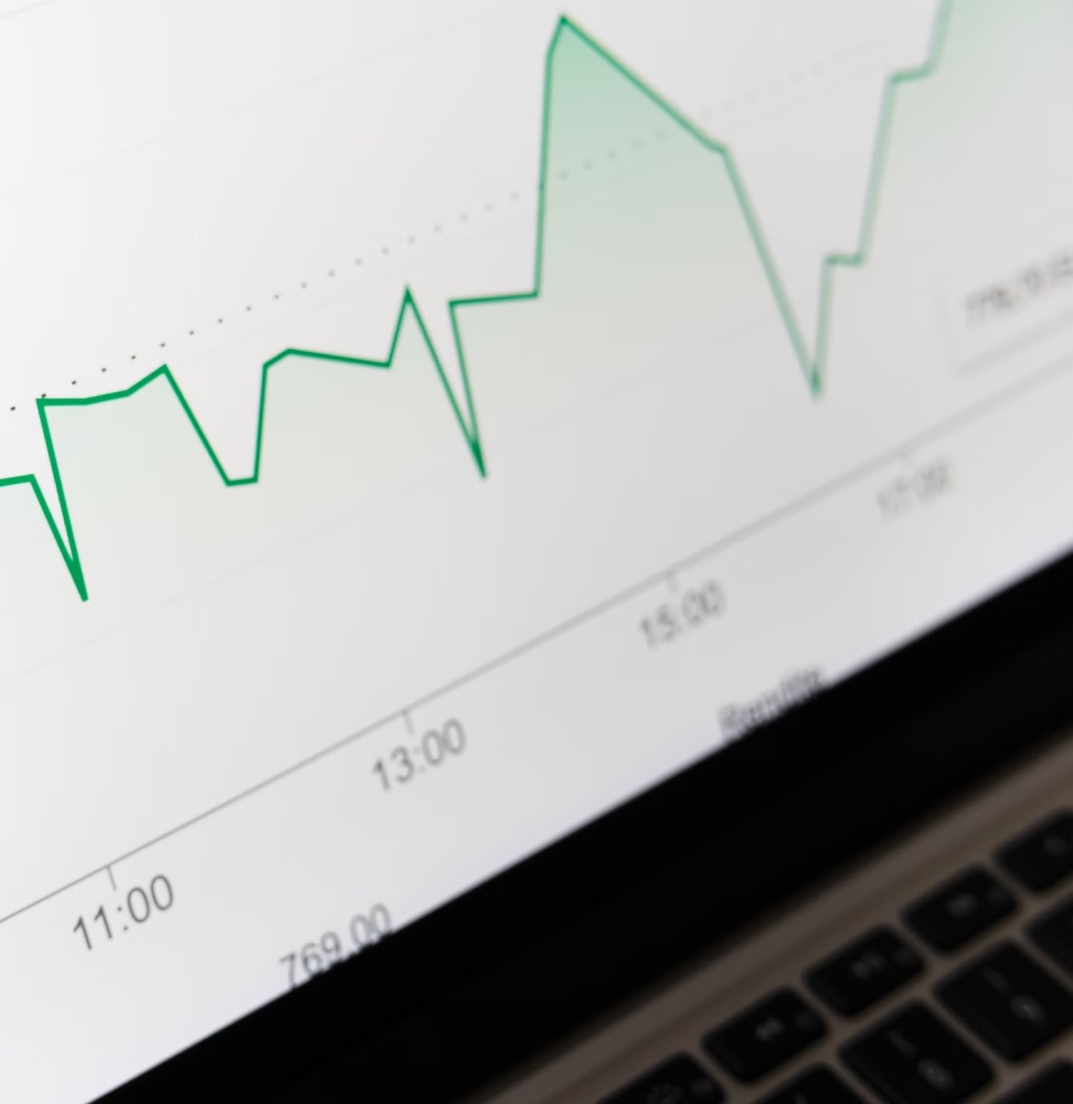 A laptop screen showing a rising line chart