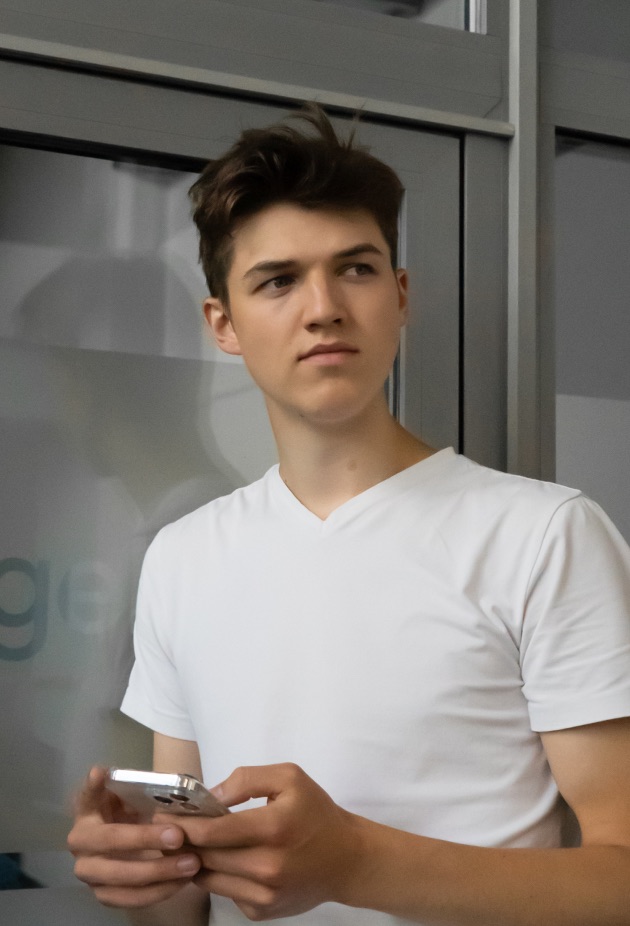 A young team member holding a phone