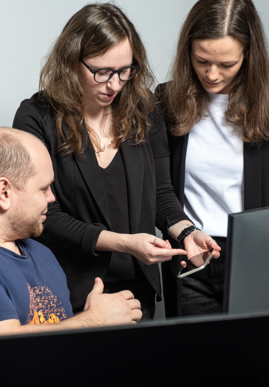 Velocity Lab mentors reviewing work with a founder at a desk